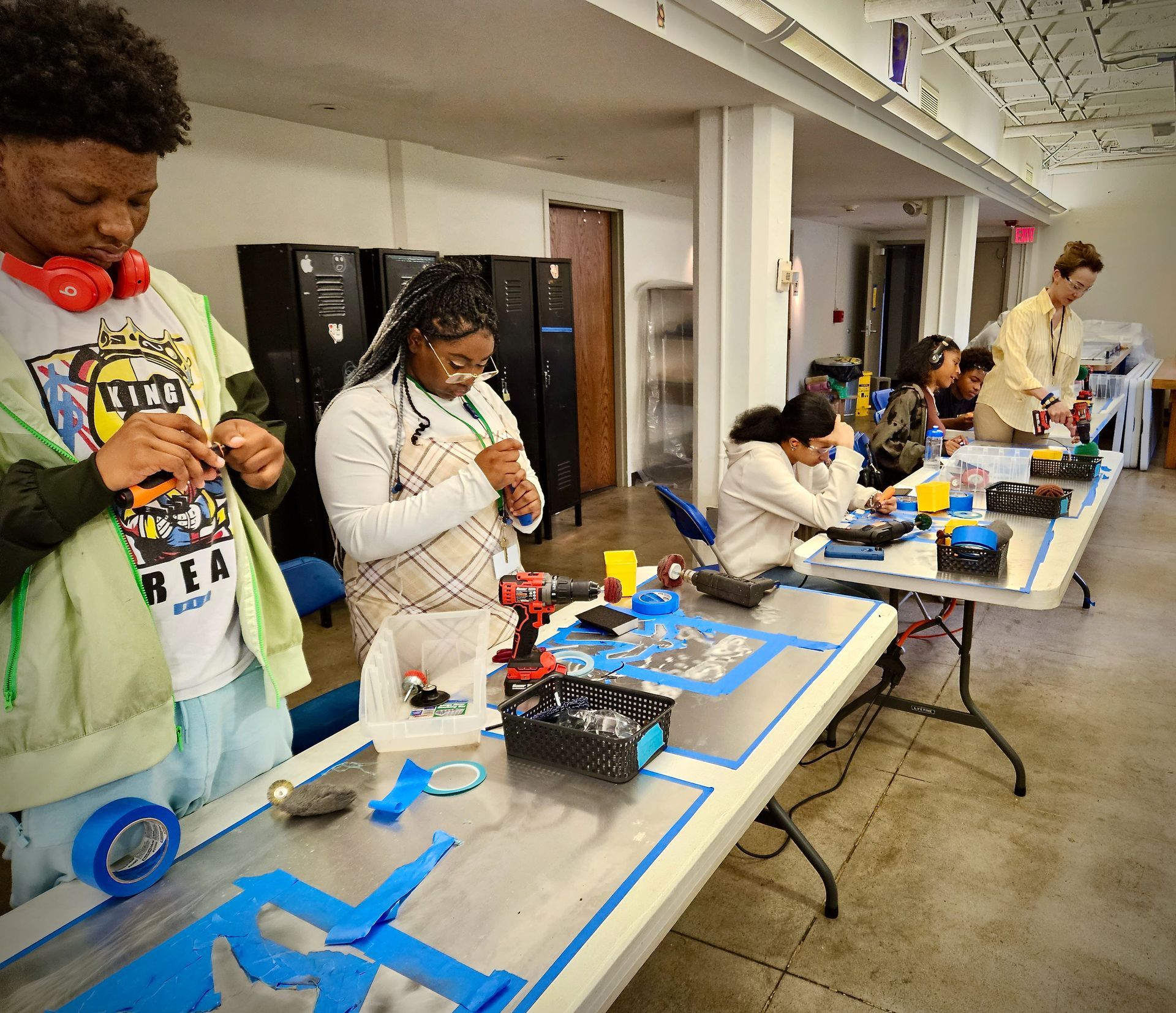 A group of people are working on a project at a table.