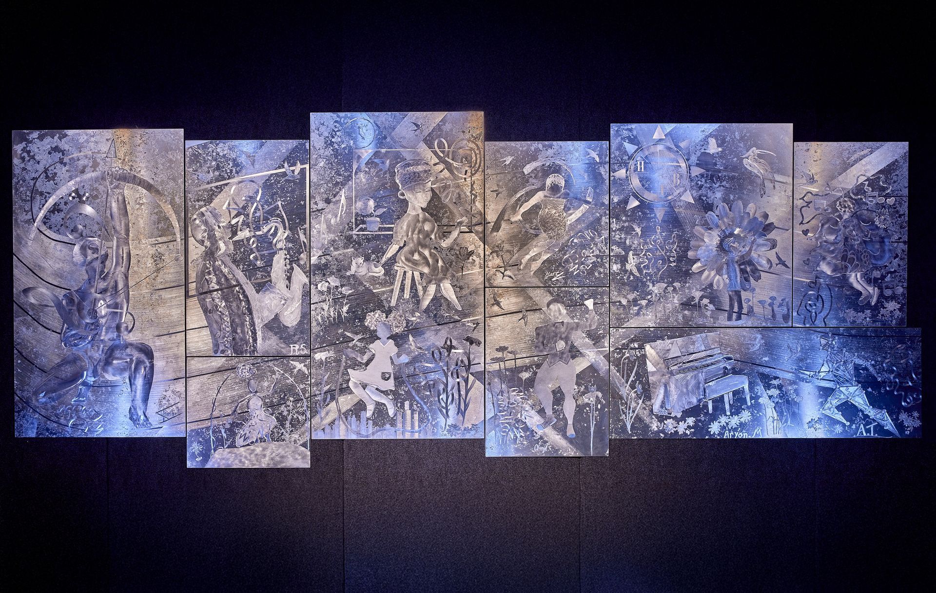 A row of paintings on a wall with a dark background