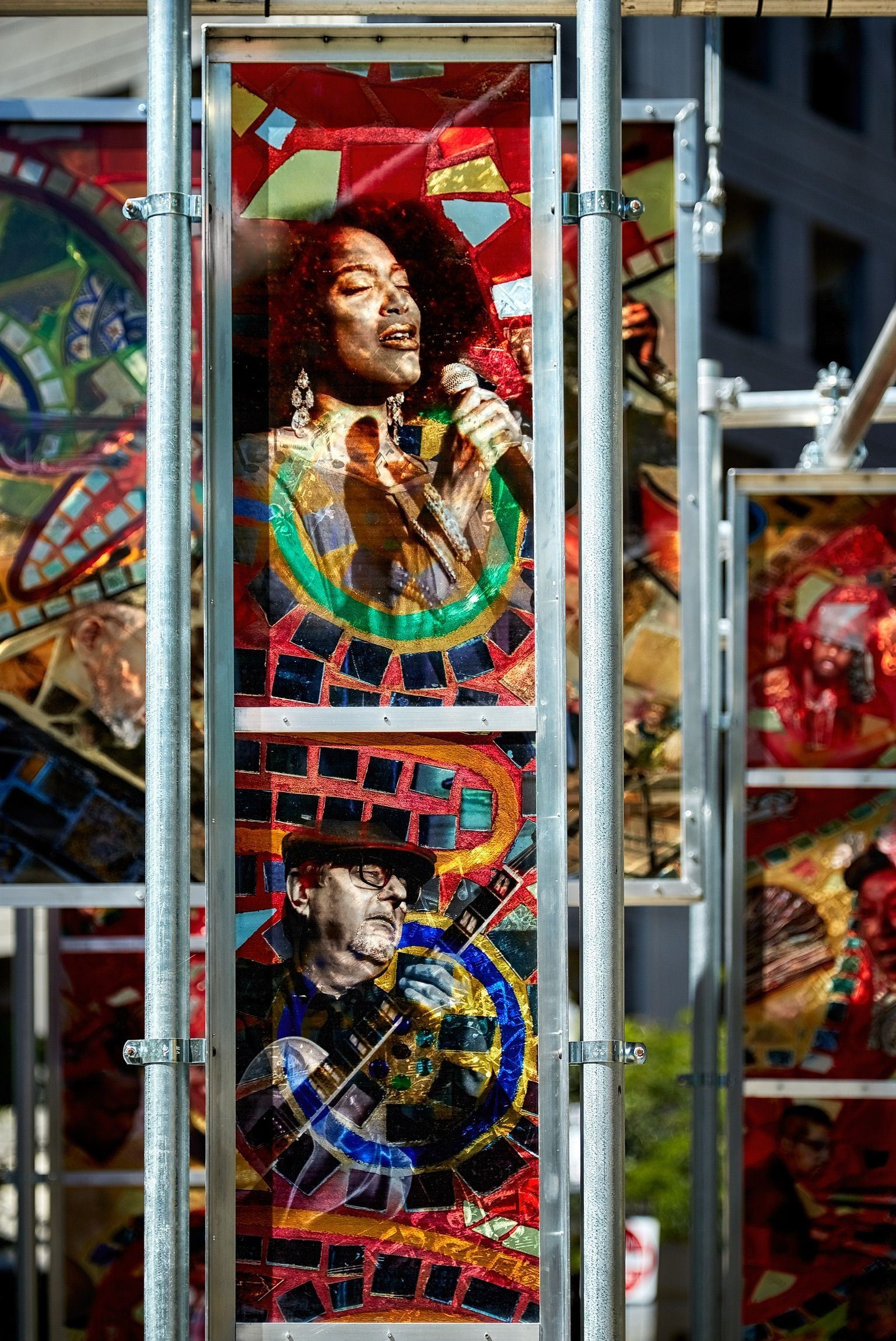 A woman is singing into a microphone in a stained glass window.