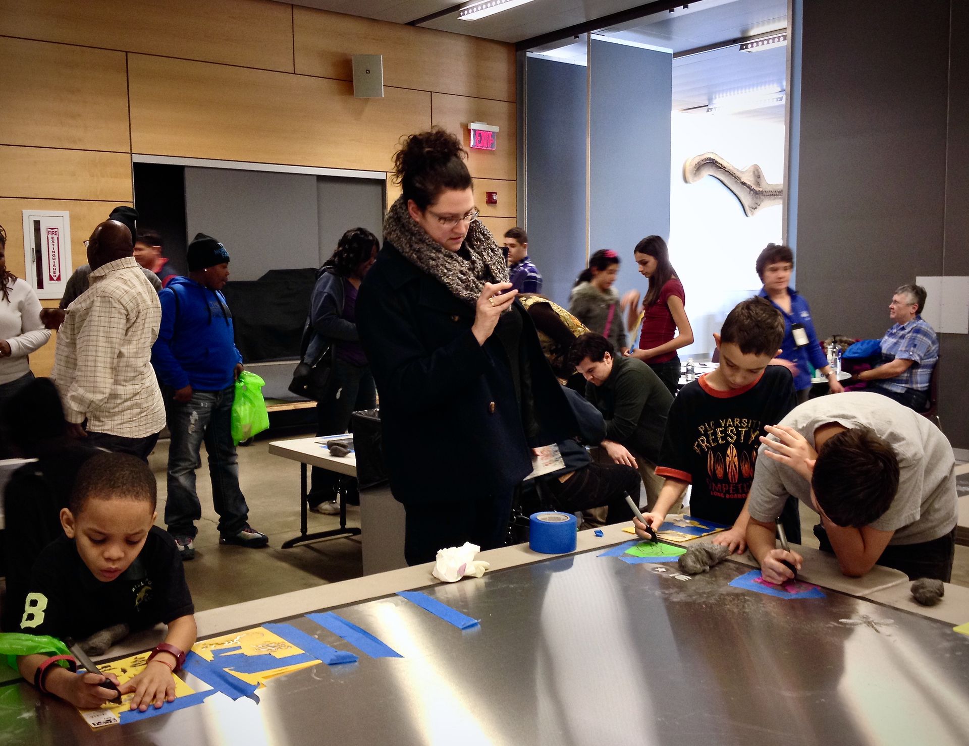 A group of people are sitting around a table with tape on it
