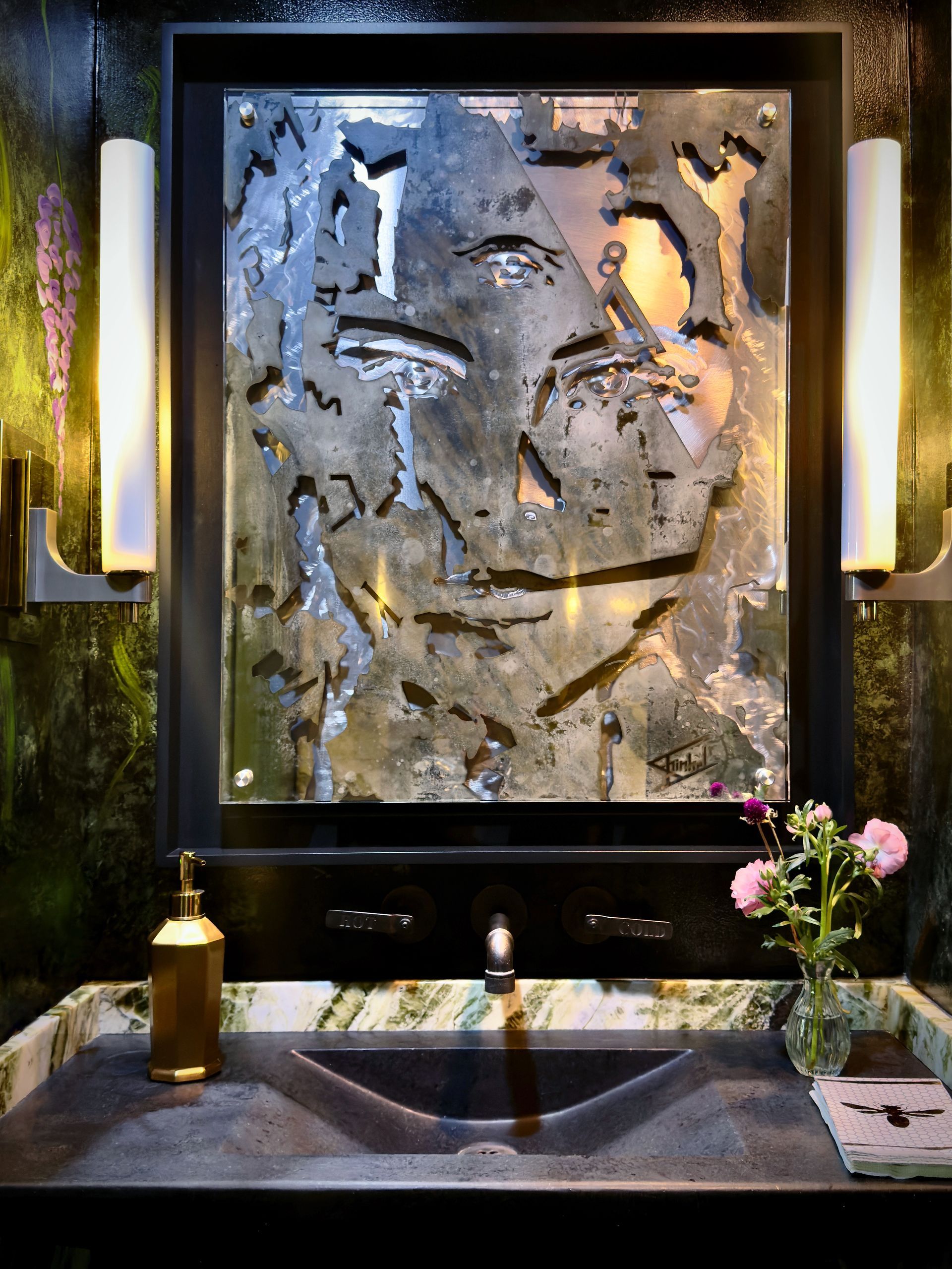 A bathroom sink with a picture of a face on it