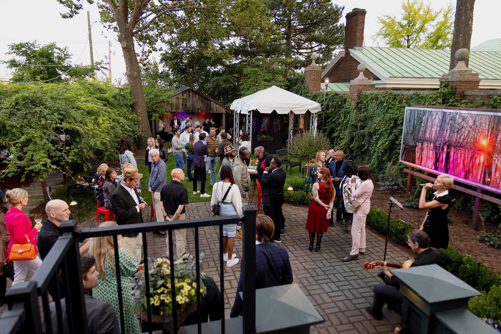 A large group of people are standing in a garden.