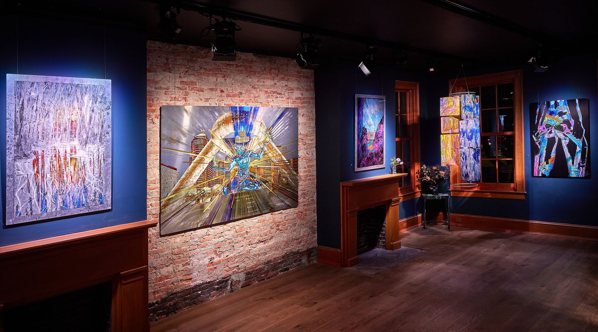 A room with paintings on the wall and a fireplace.