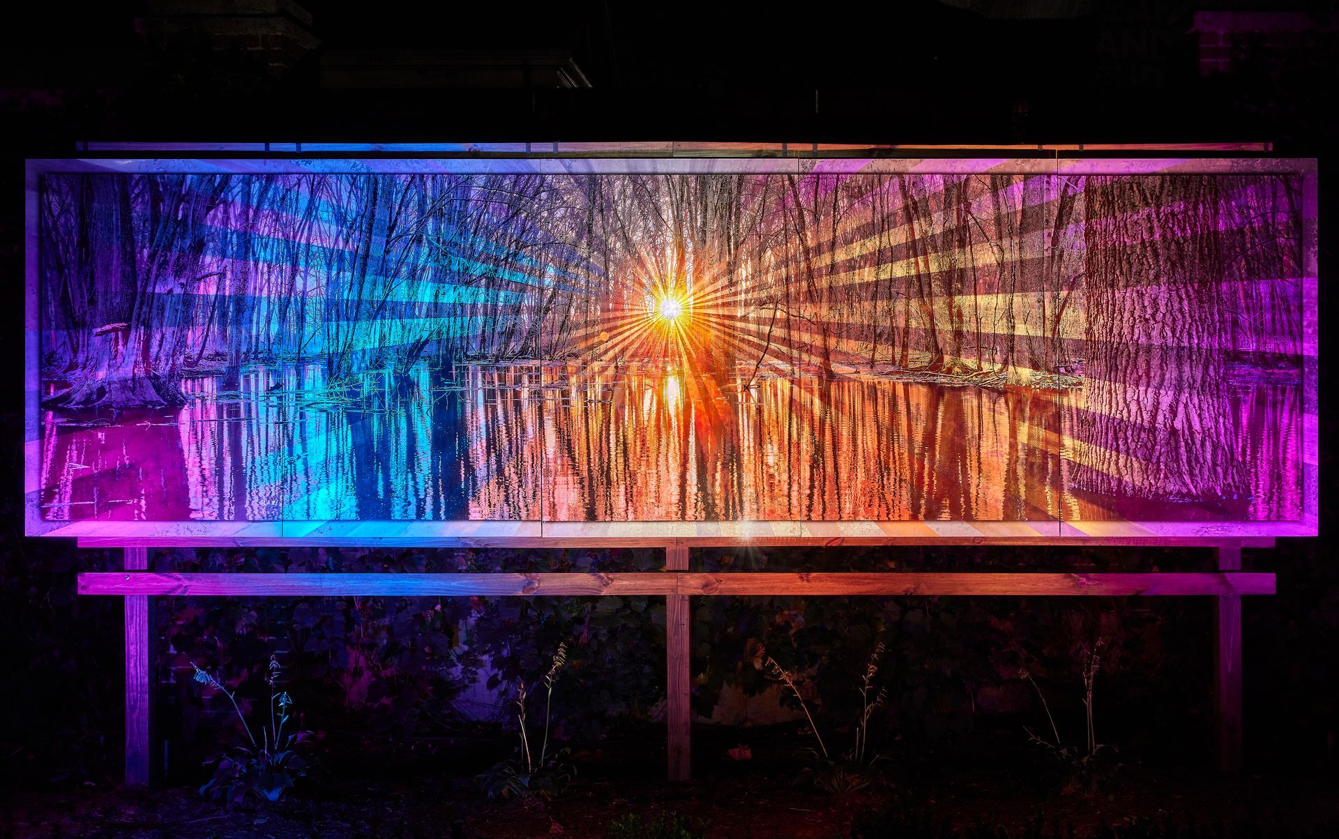 A large painting with a lot of lights on it is hanging on a wall.