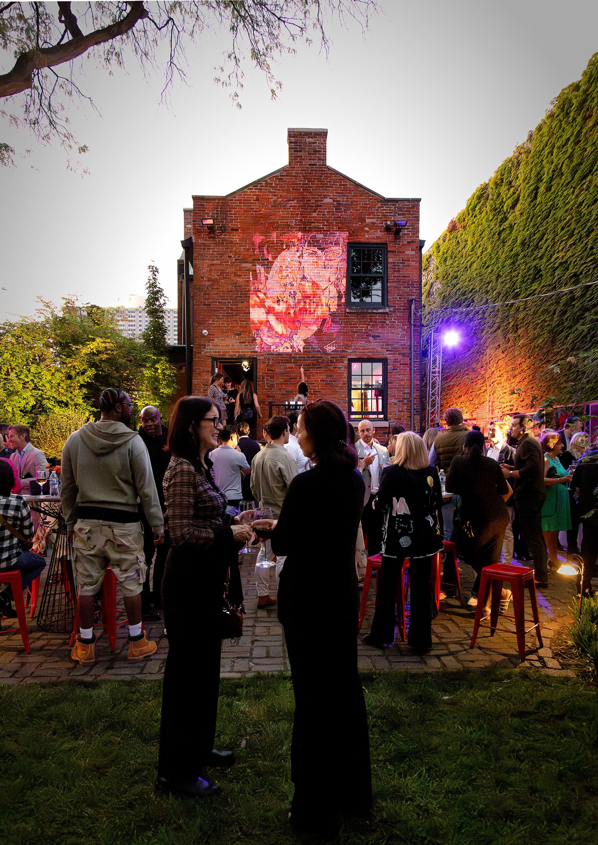 A group of people standing in front of a brick building