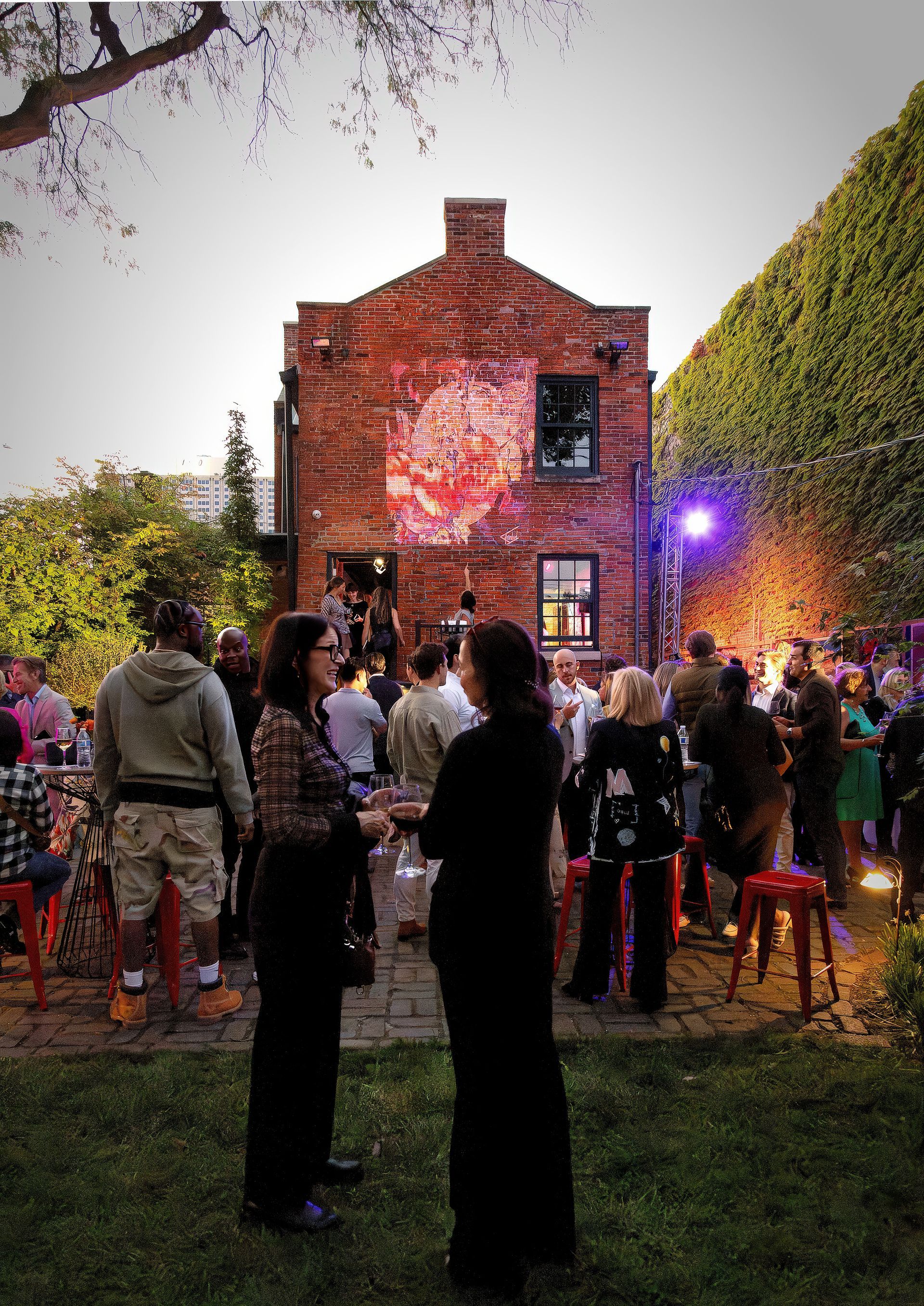 A group of people standing in front of a brick building