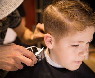 Portrait of male child at the barber shop to cut his hair