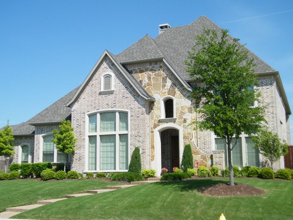 A large brick house with a gray roof
