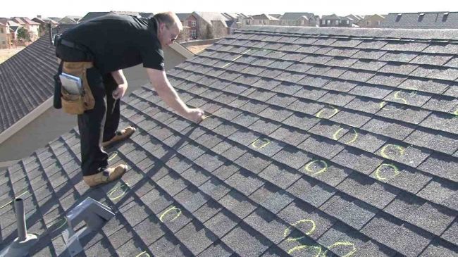 A man is working on the roof of a house