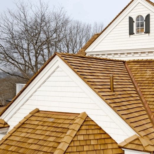 A white house with a wooden roof and a window