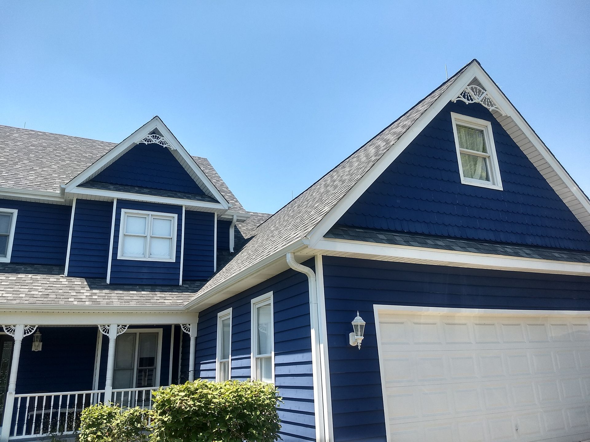 A blue house with a white garage door