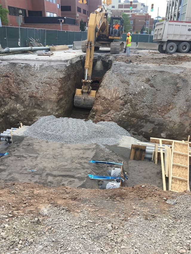 a construction site with a bulldozer and a dump truck .