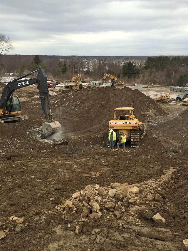 a group of construction workers are working on a construction site .