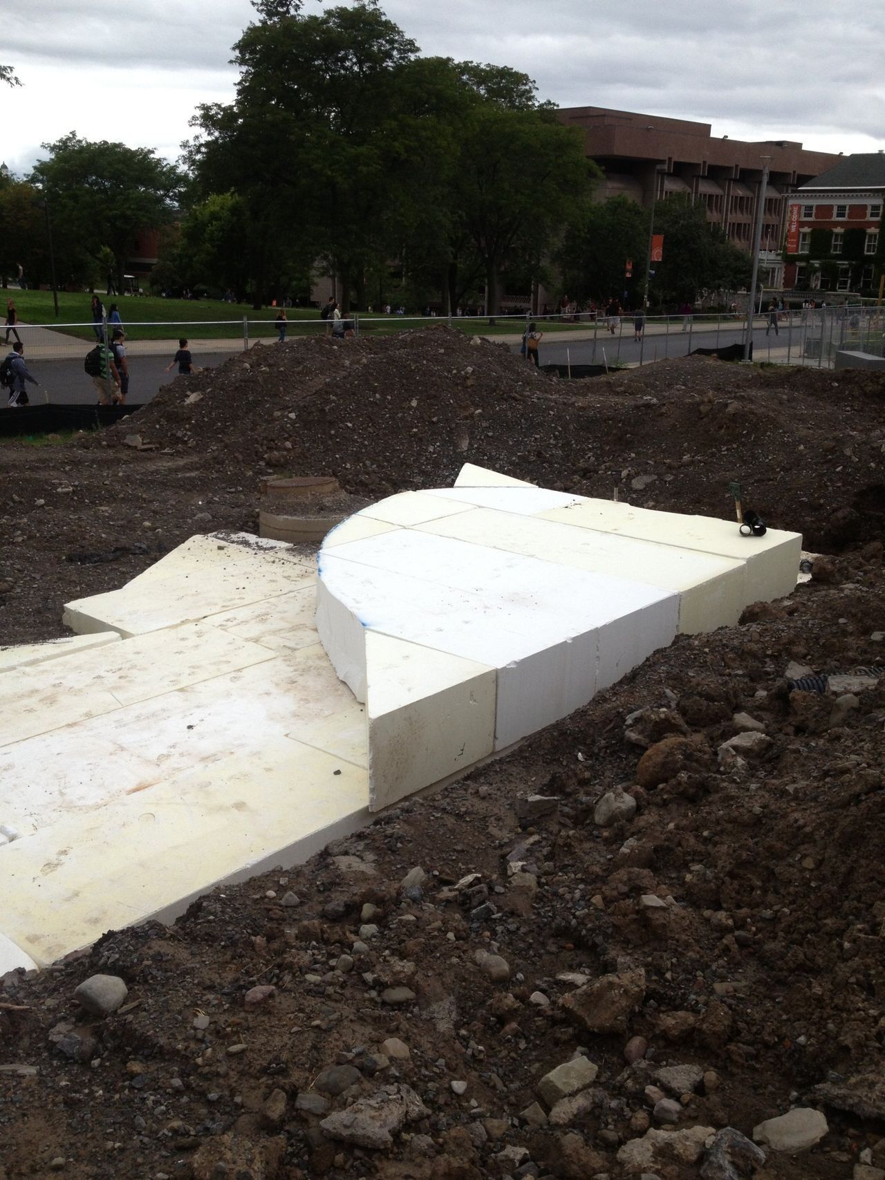 a large piece of styrofoam is sitting on top of a pile of dirt