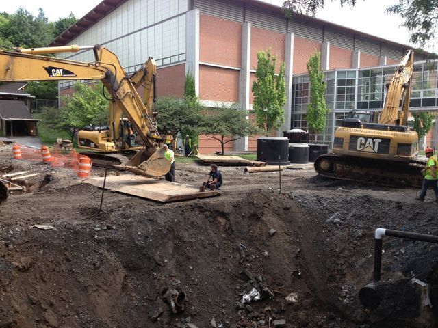 a construction site with a cat excavator in the foreground