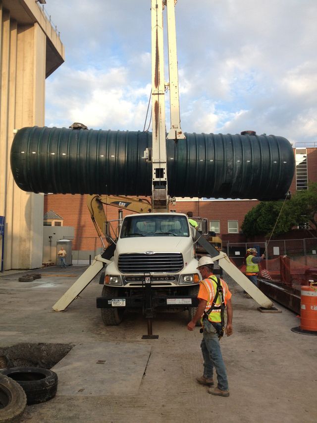 a man is standing next to a truck that is carrying a large object