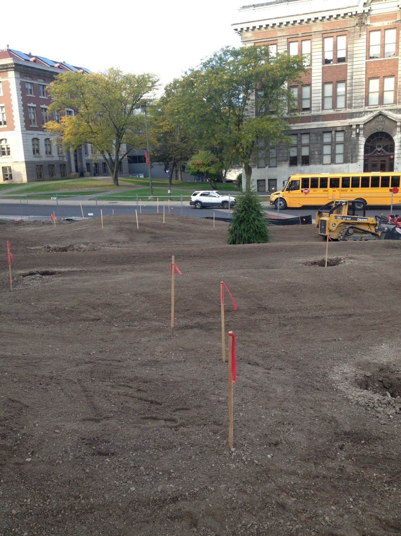 a yellow school bus is parked in front of a building