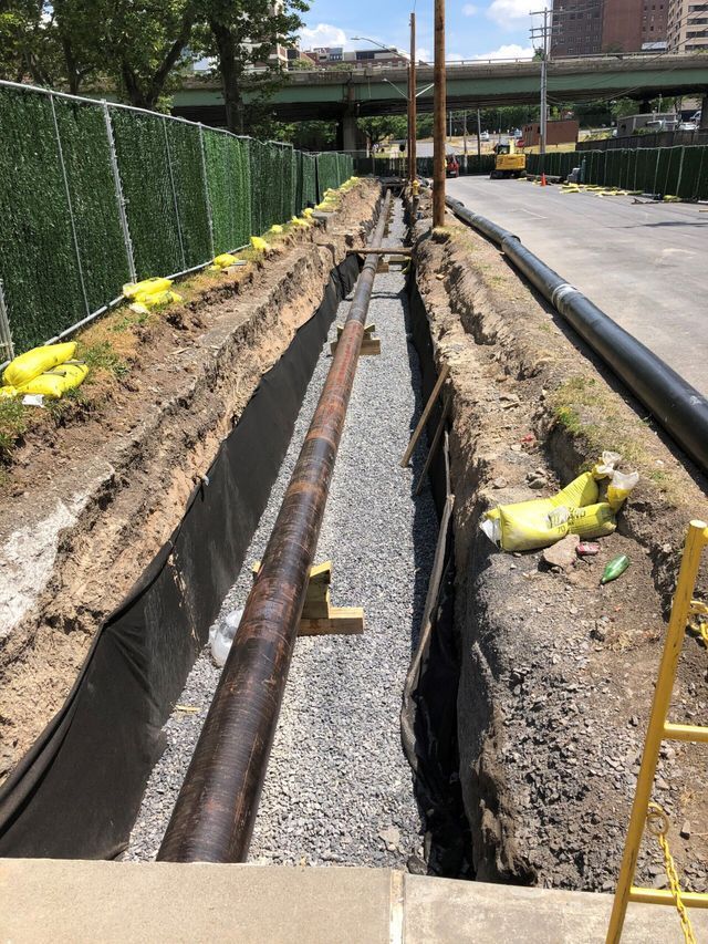 a construction site with a lot of pipes in the ground