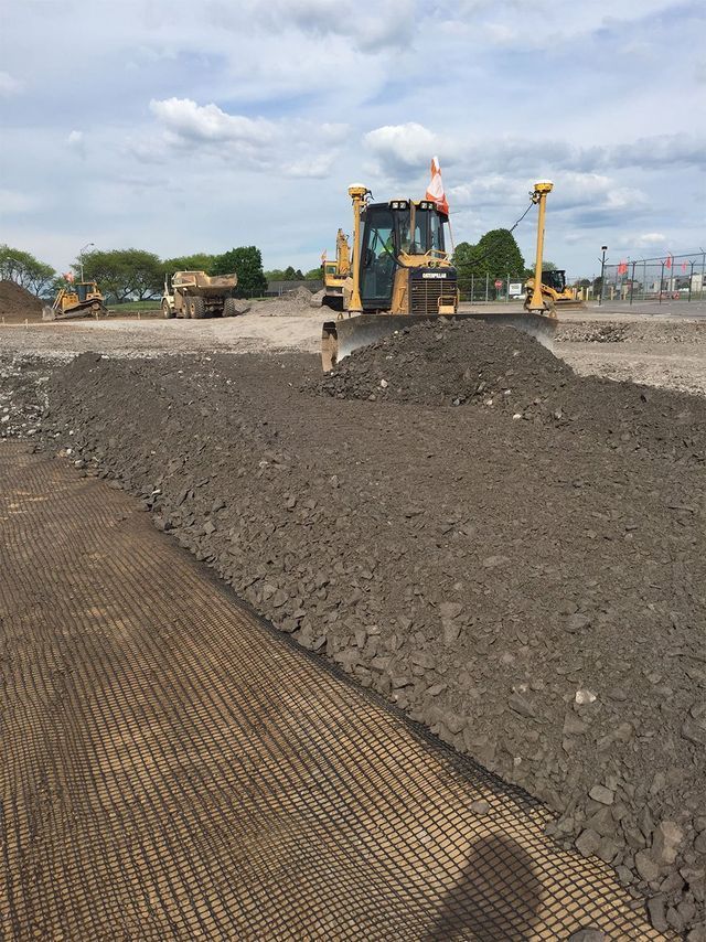 a bulldozer is working on a dirt road