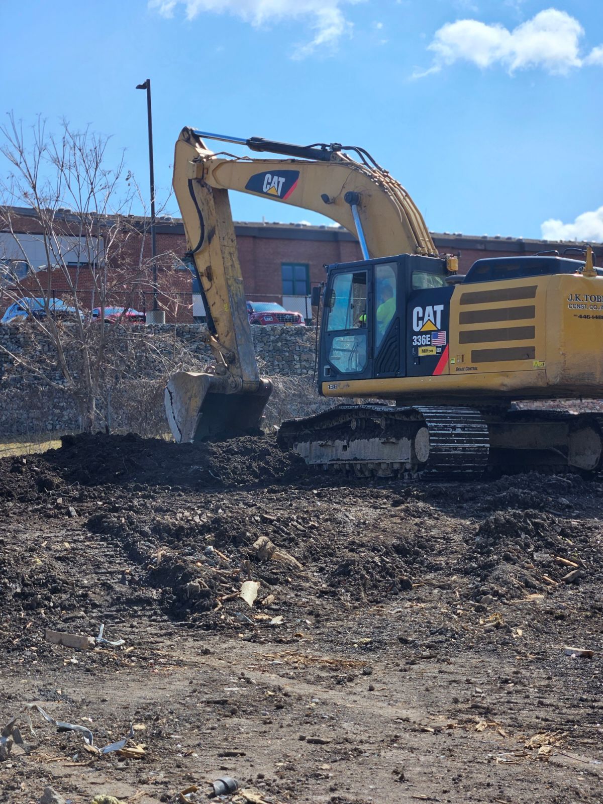 a cat excavator is digging in a dirt field