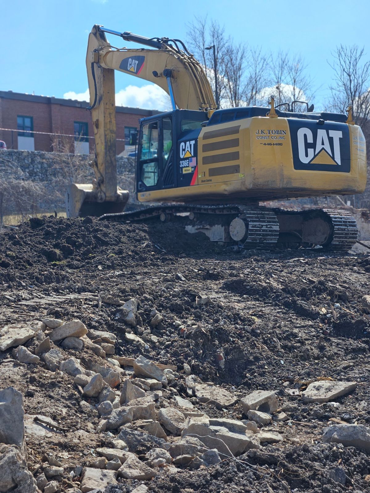a cat excavator is digging in a dirt field