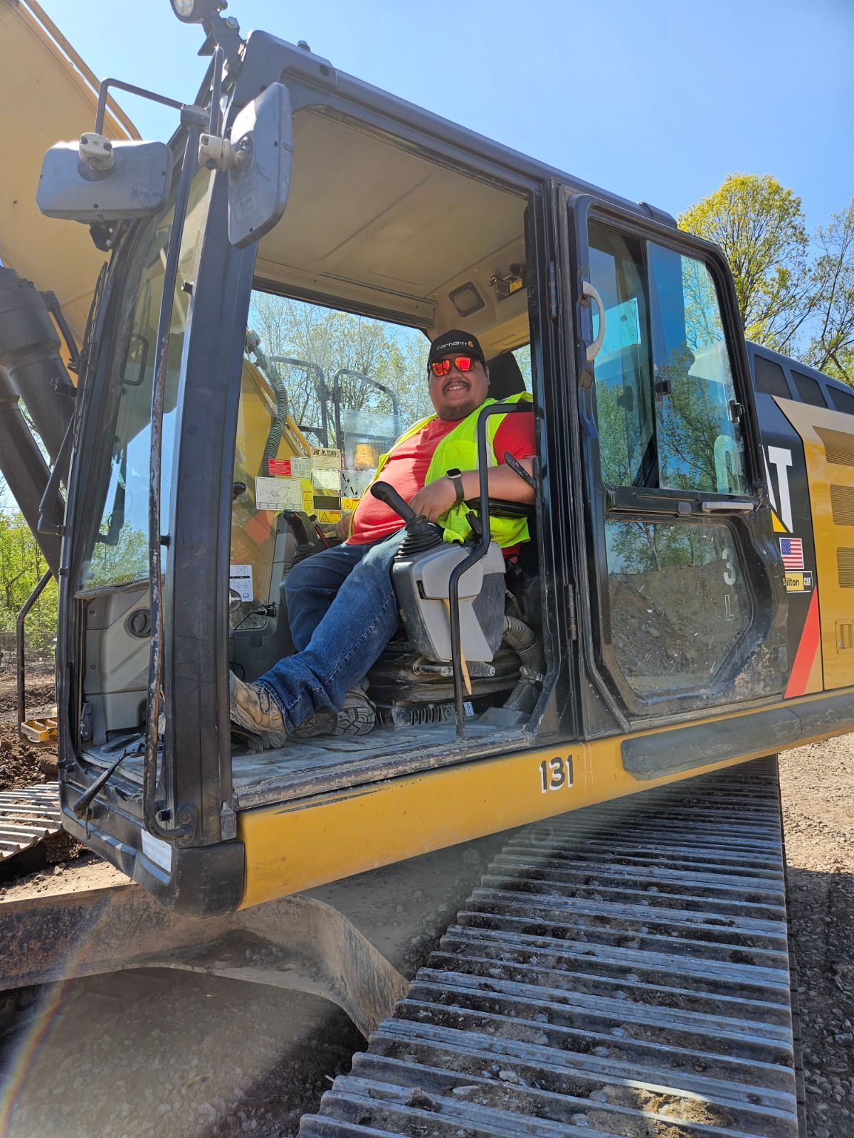 a man is sitting in the cab of a bulldozer .
