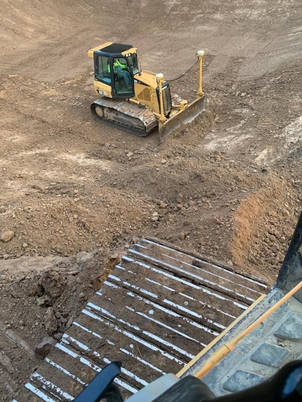 a bulldozer is moving dirt on a construction site .