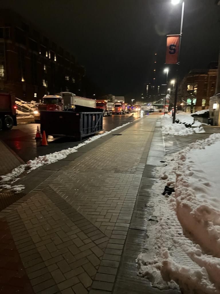a snowy sidewalk with a sign that says ' us ' on it