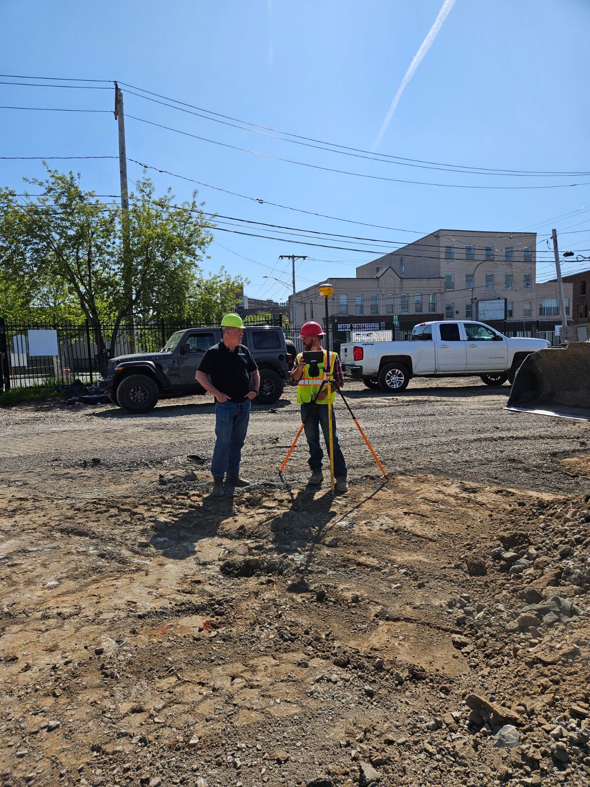 a man and a woman are standing in a dirt field .