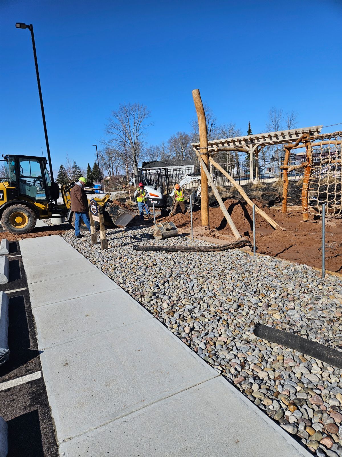 a group of construction workers are working on a playground .