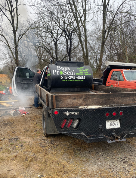 A person works near a truck carrying a 
