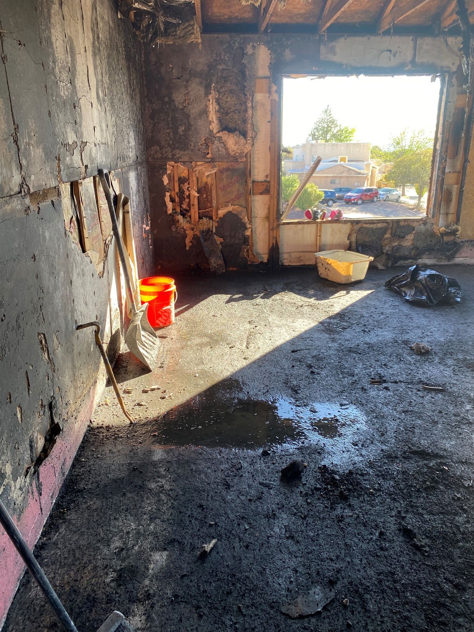 A room with a lot of dirt on the floor and a window.