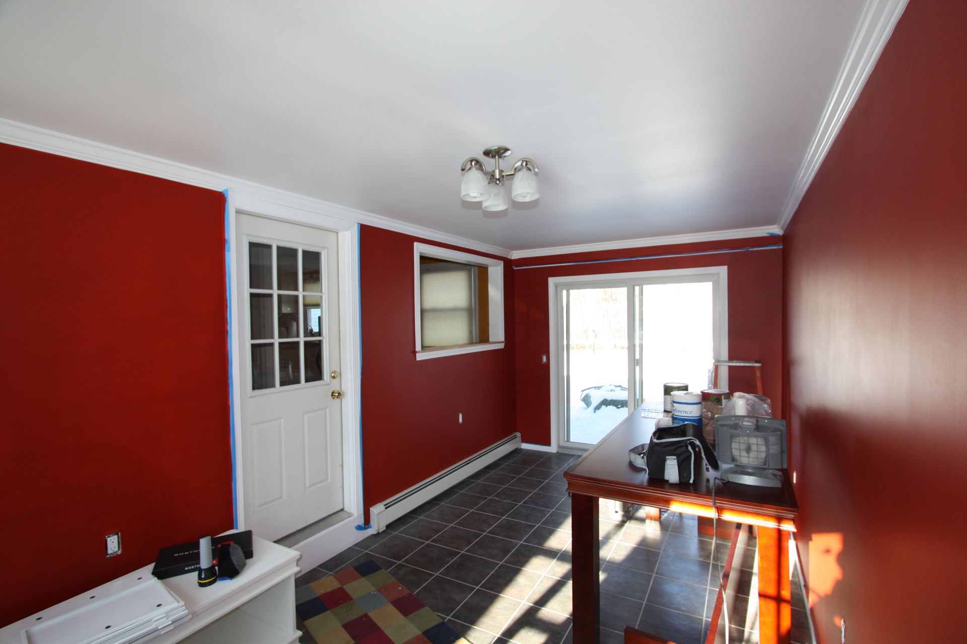 A room with red walls and a white door.
