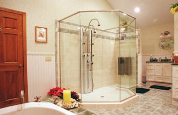 A bathroom with a walk in shower and a bathtub.