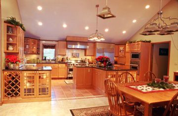 A kitchen with a table and chairs in it.