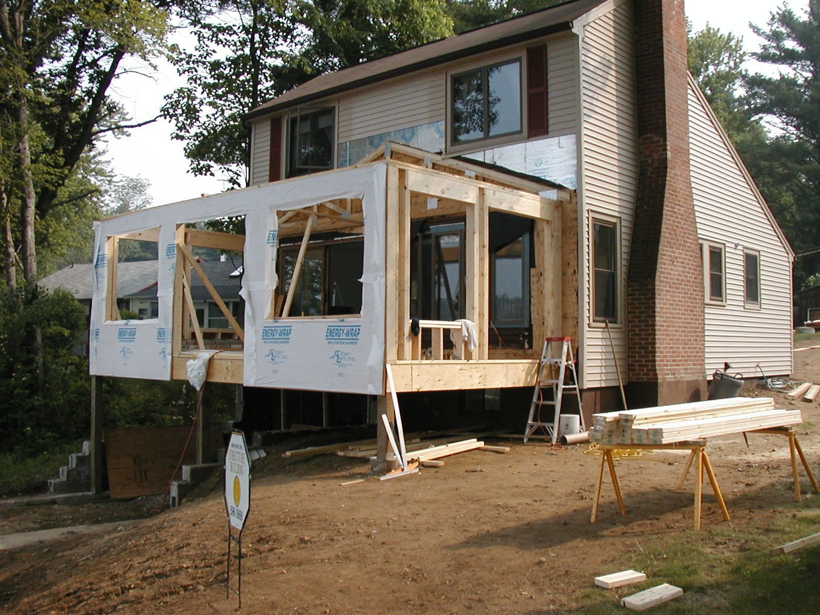 A house is being remodeled with a deck being built.