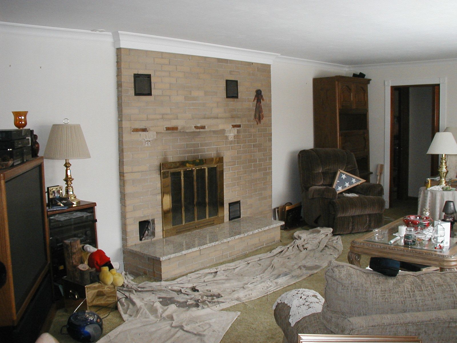 A living room with a fireplace and a couch.