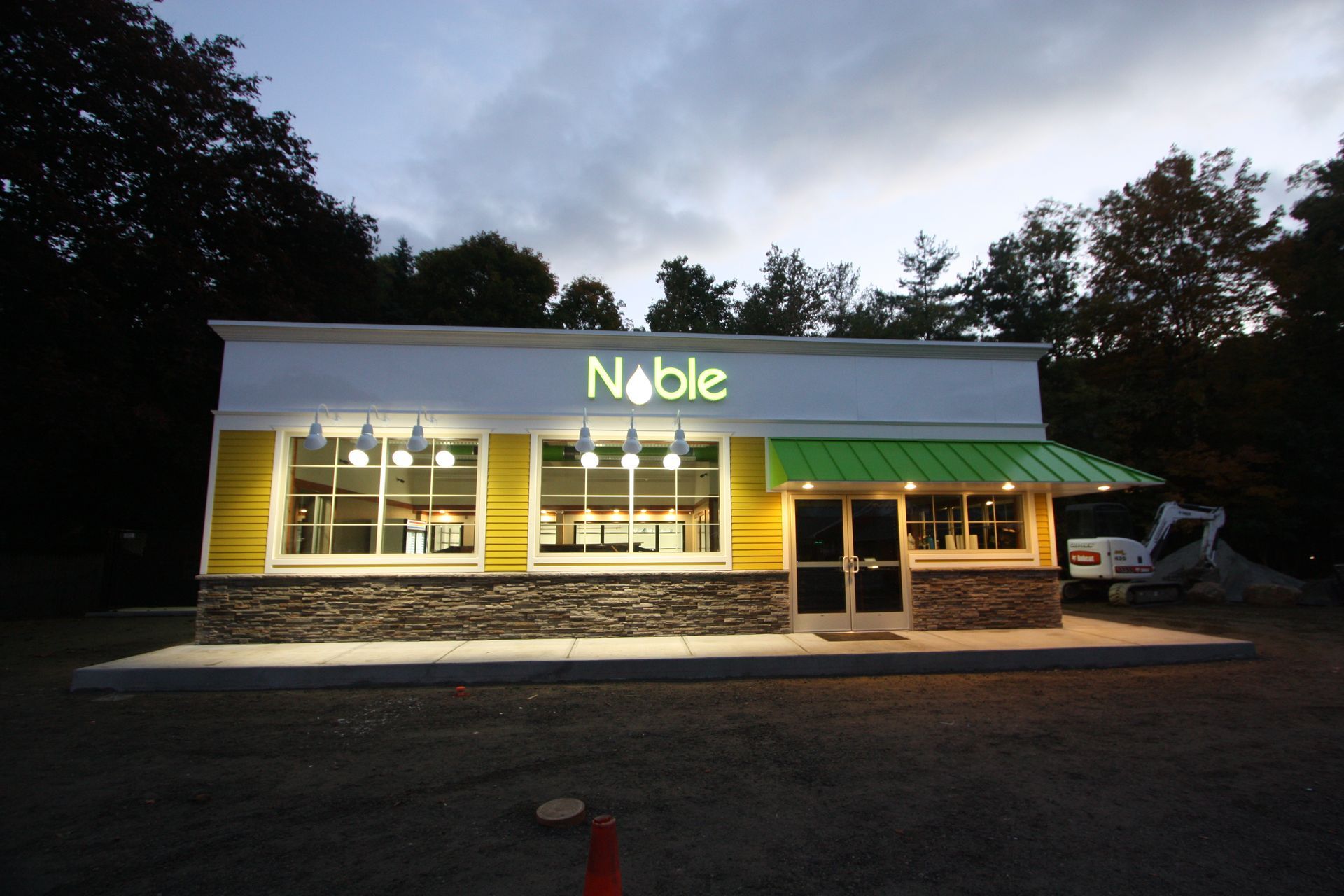 A noble restaurant is lit up at night.