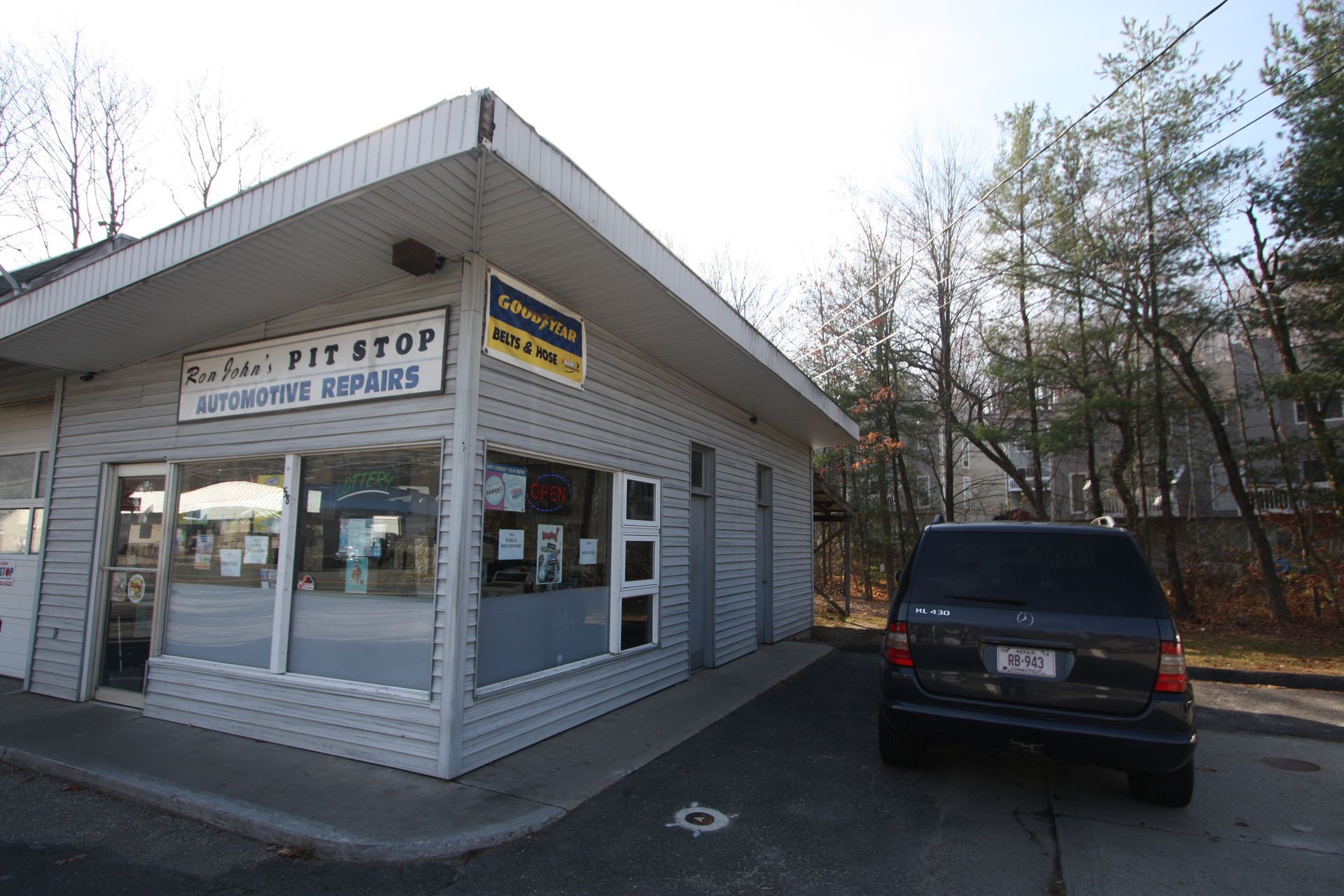 A car is parked in front of a pie stop.