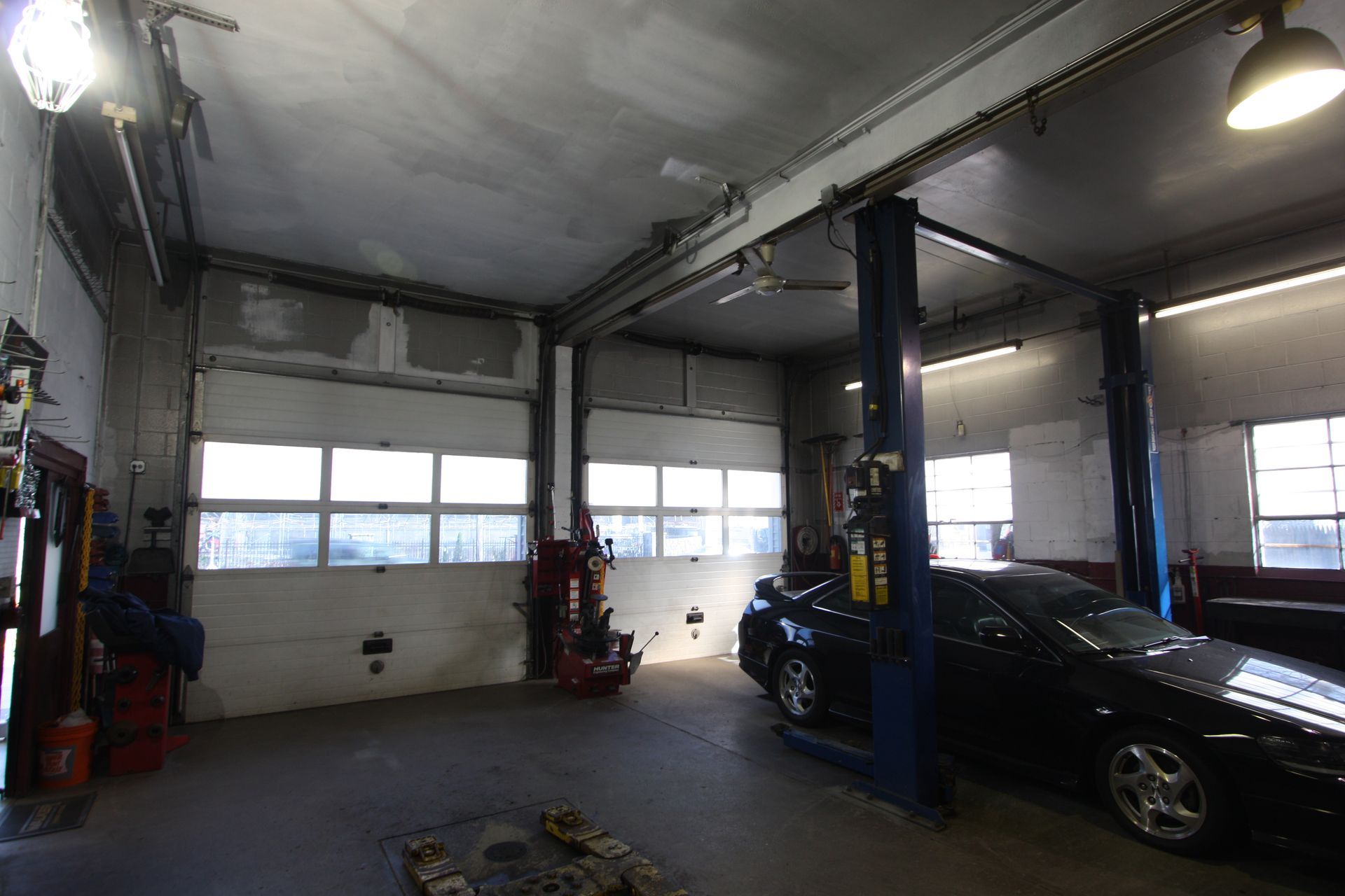 A car is on a lift in a garage.