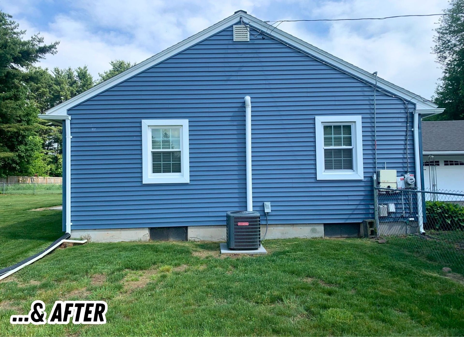 Blue house exterior with white trim and a downspout, shown as an “after” renovation shot.