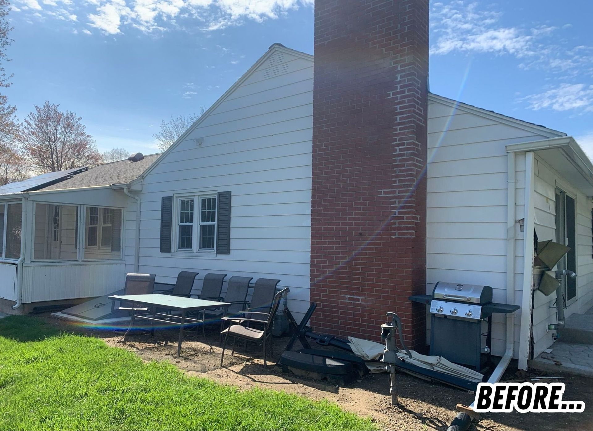 Back of white house with tall brick chimney, patio furniture, and BEFORE label