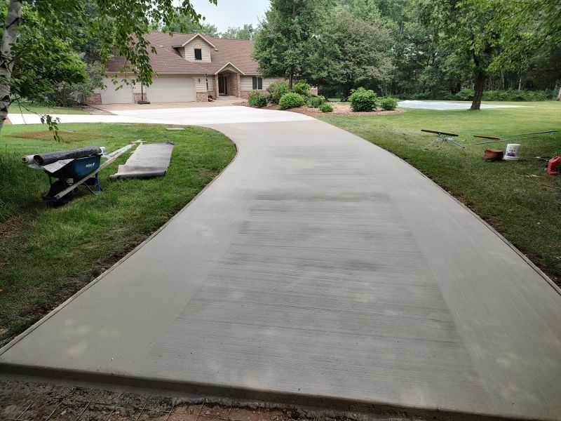 A concrete driveway is being built in front of a house.