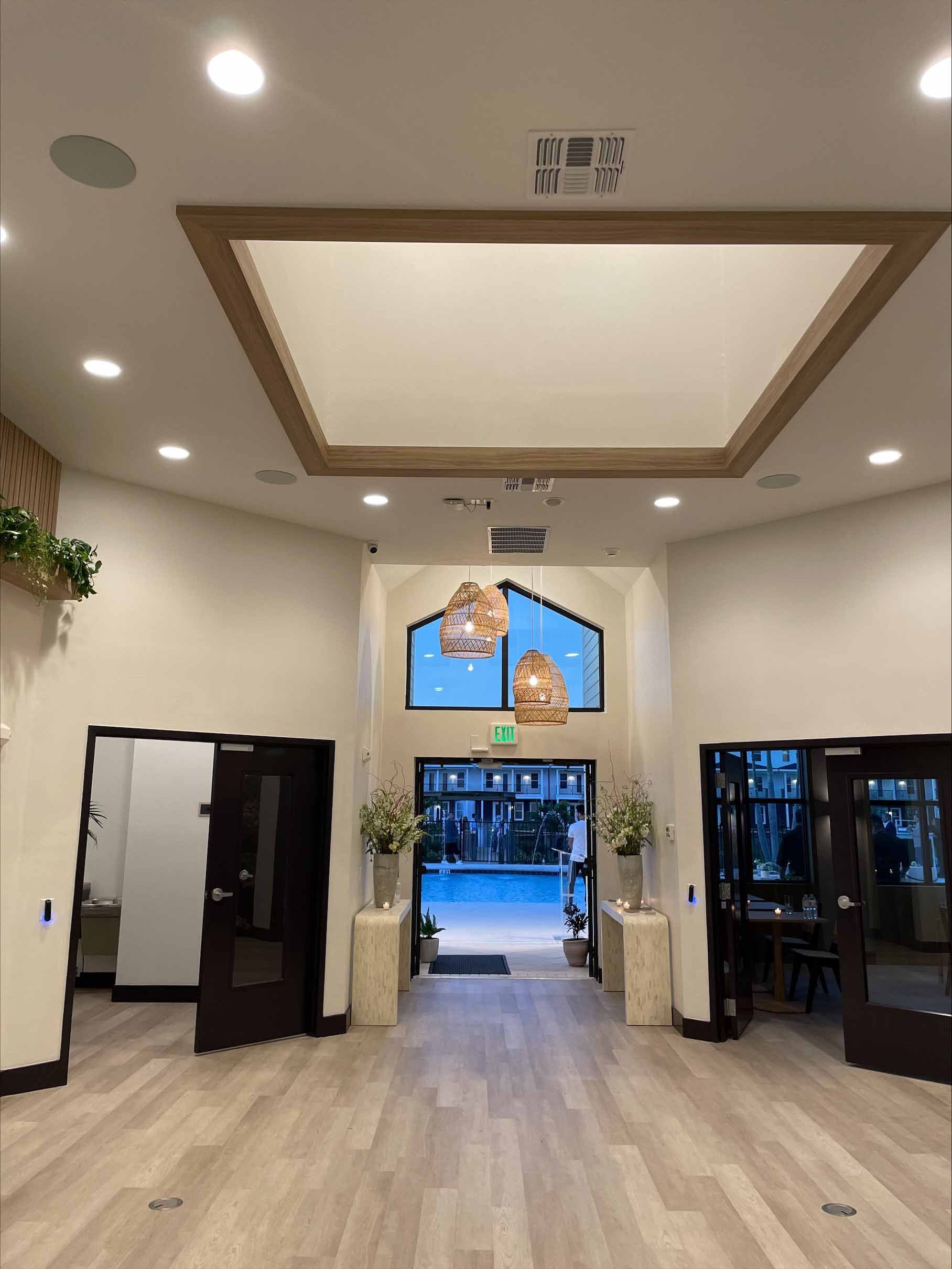 Interior lobby with doors, a window, and decorative hanging lights.
