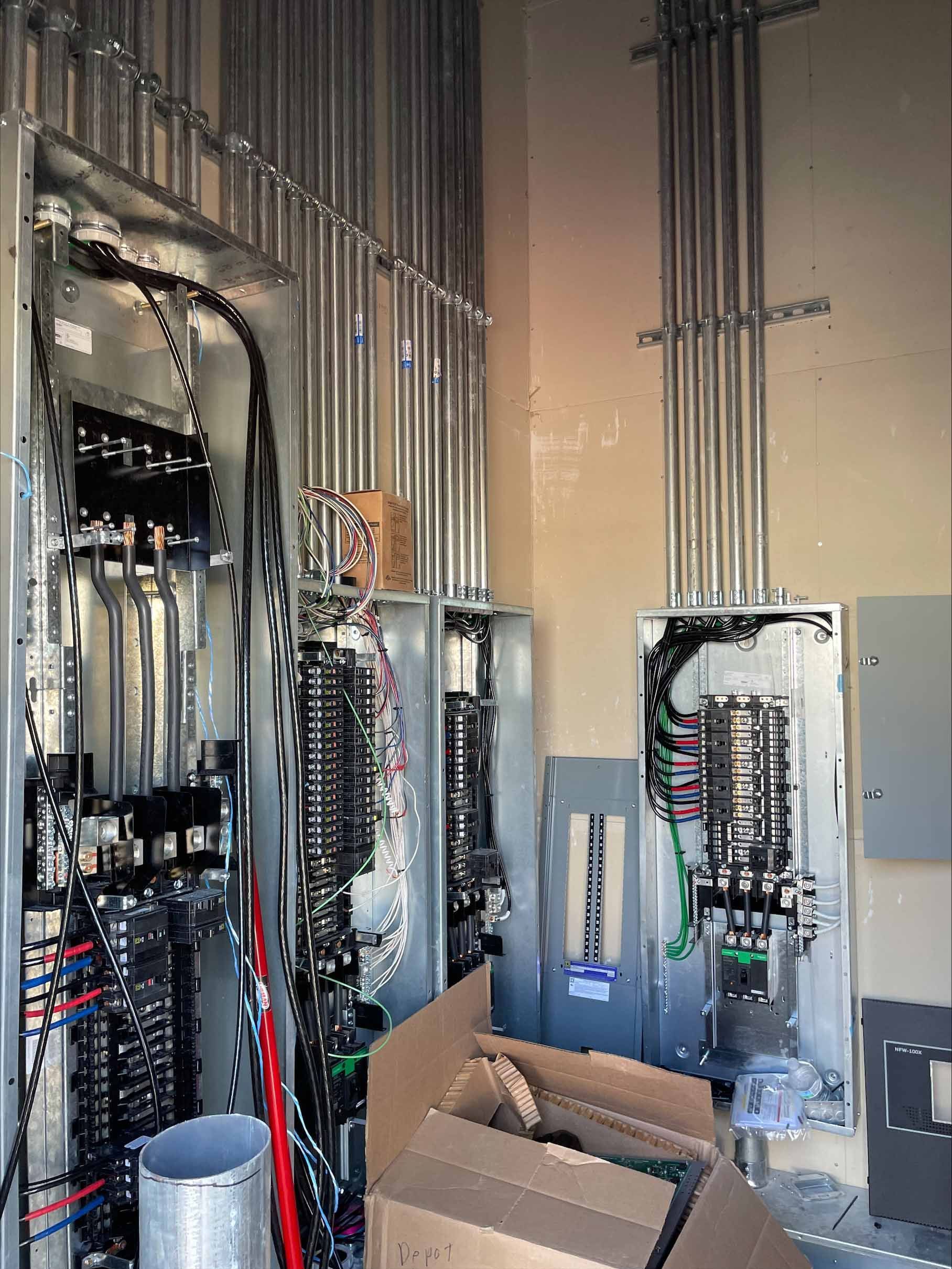 Electrical panels with conduit, wires. Installation of a new electrical system in a building.