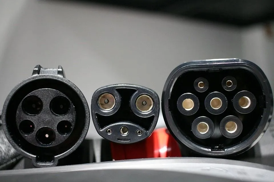 Three different electric vehicle charging connector types: from left: Type 2, CCS, and CHAdeMO.
