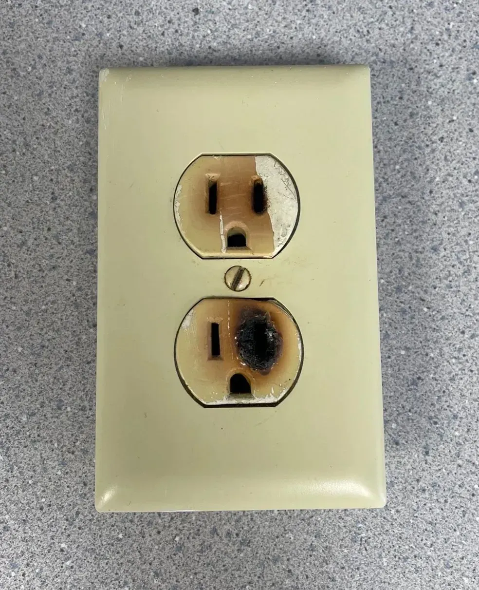 Discolored outlet with signifcant signs of heat damage.