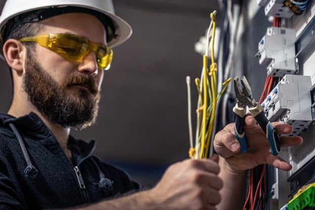 A licensed electrician is connecting the electrical system of a new swimming pool