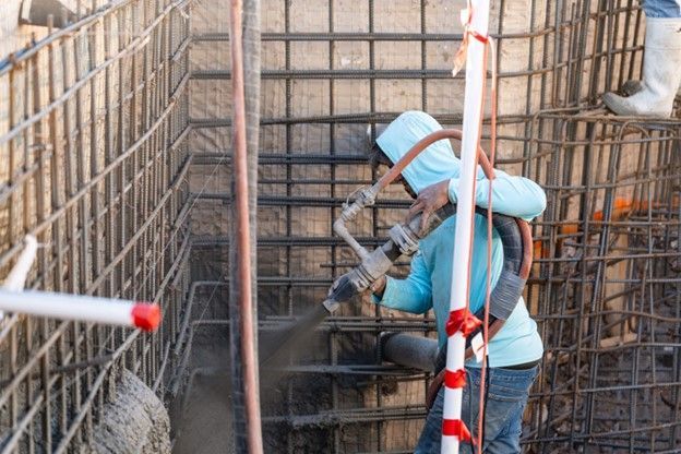 A Family Pools worker is creating a new pool shell