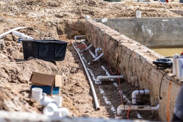 Pre-plumbed lines of a new swimming pool that is under construction